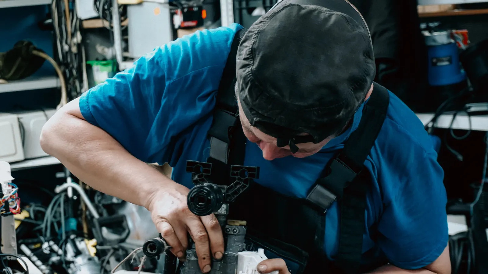 A technician working on machinery in a workshop