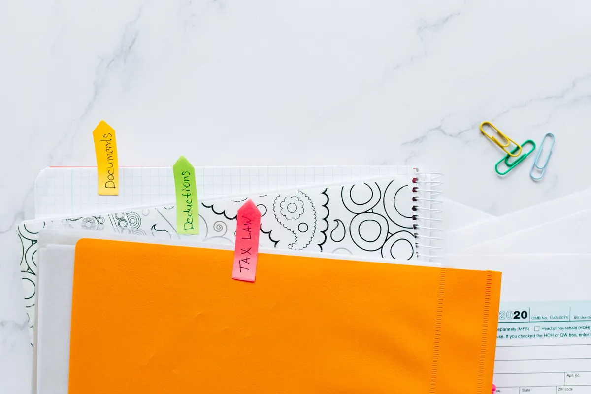 Labelled dividers and folders arranged on a desk