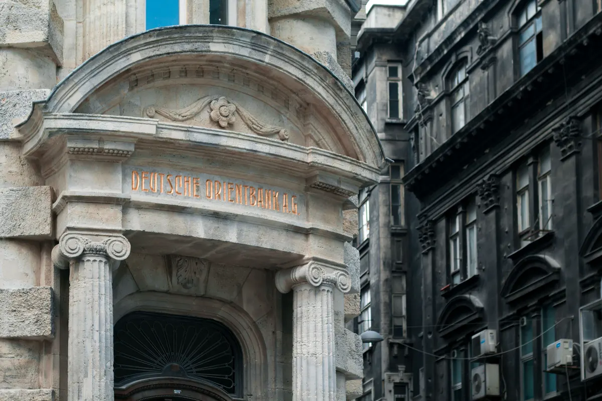 The stone facade of a European bank building
