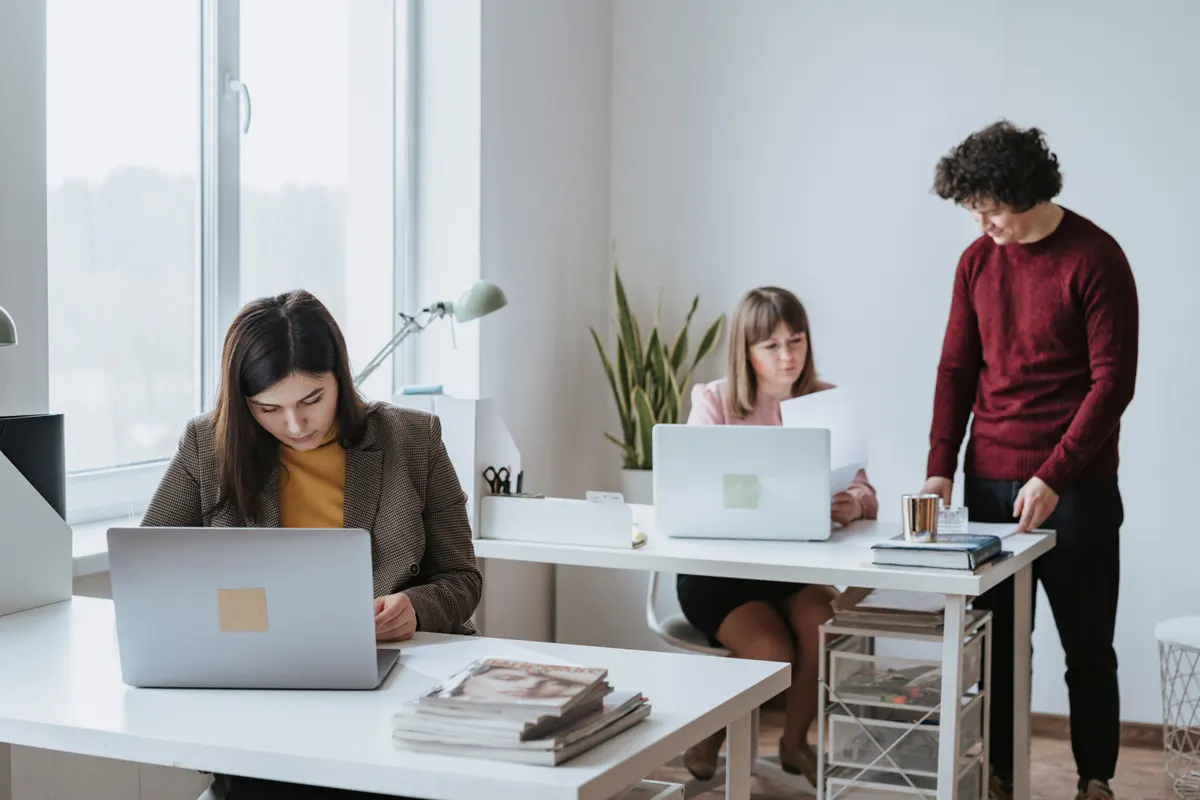 Colleagues working together at desks in an office
