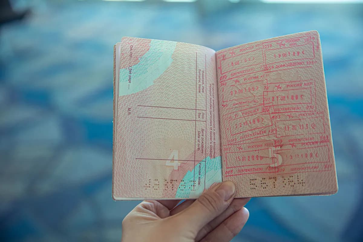 A passport open at a page of entry stamps