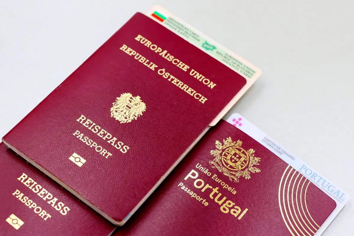 Several passports of different countries fanned out on a table