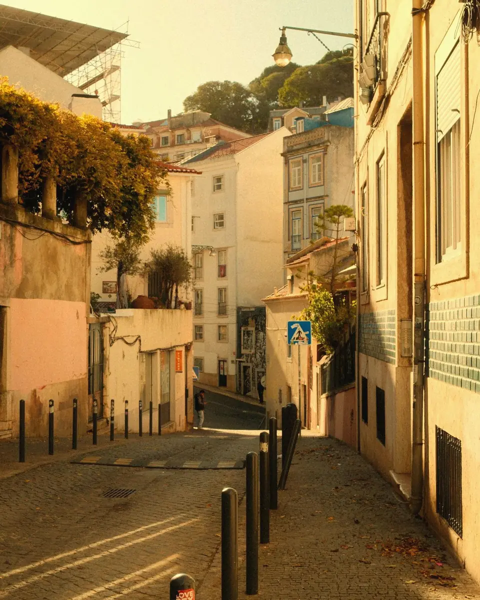 A sunlit residential street of pastel houses in Lisbon